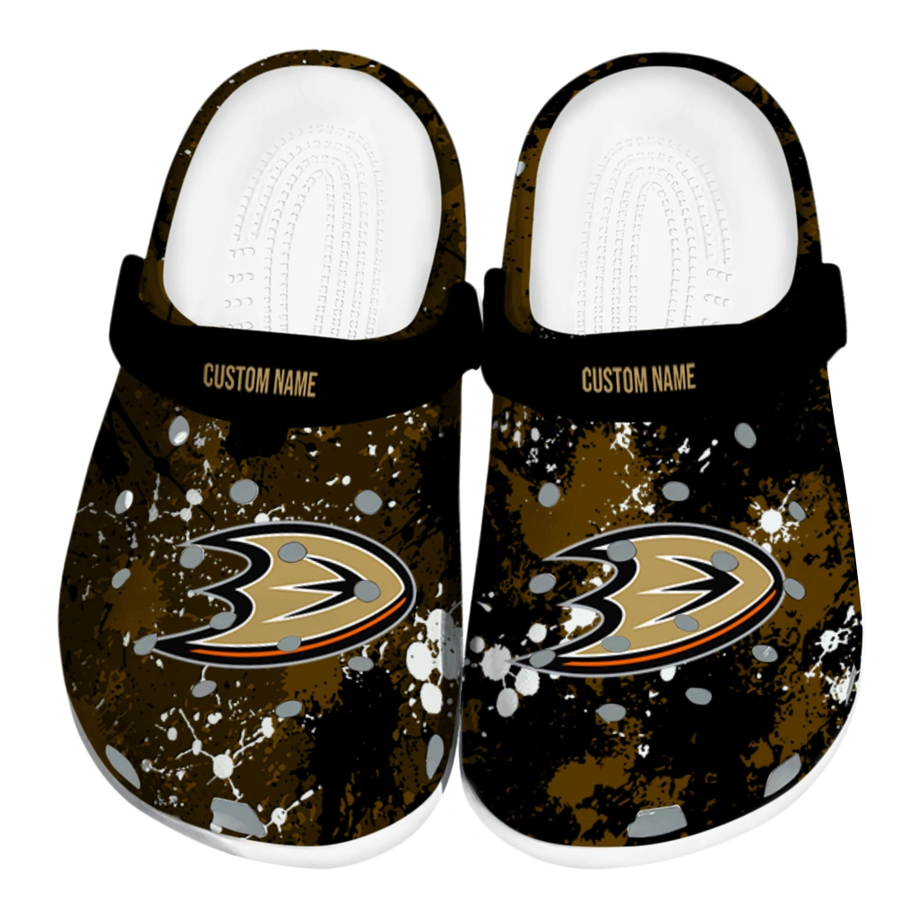 anaheim-ducks-clog-personalized-splatter-splash-gold-black-best-selling.webp anaheim ducks clog personalized splatter splash gold black best selling